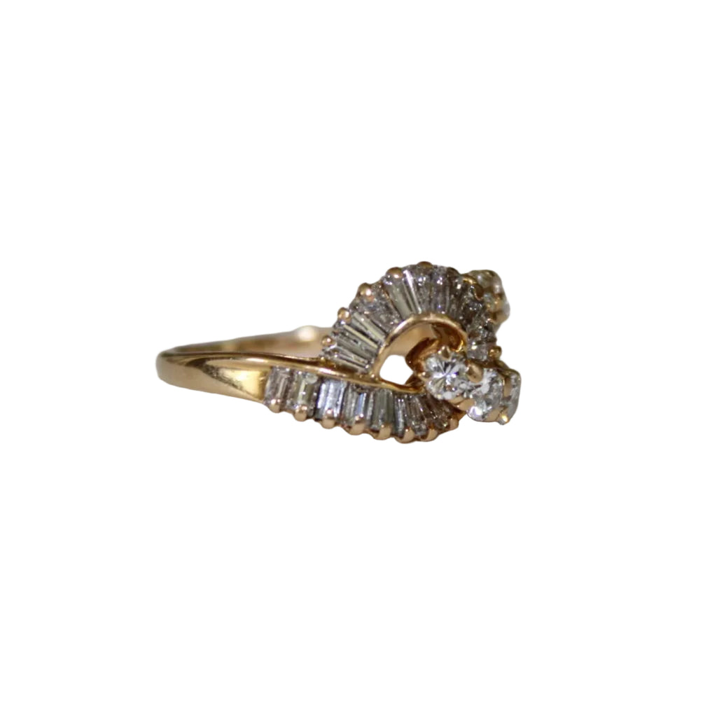 Gold ring with diamond accents on a light gray background