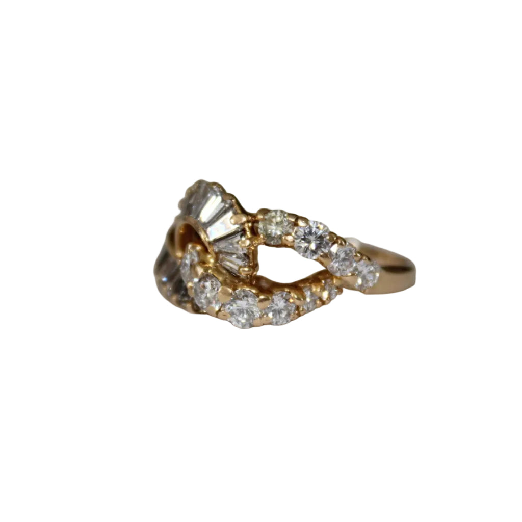 Gold ring with diamonds on a light gray background