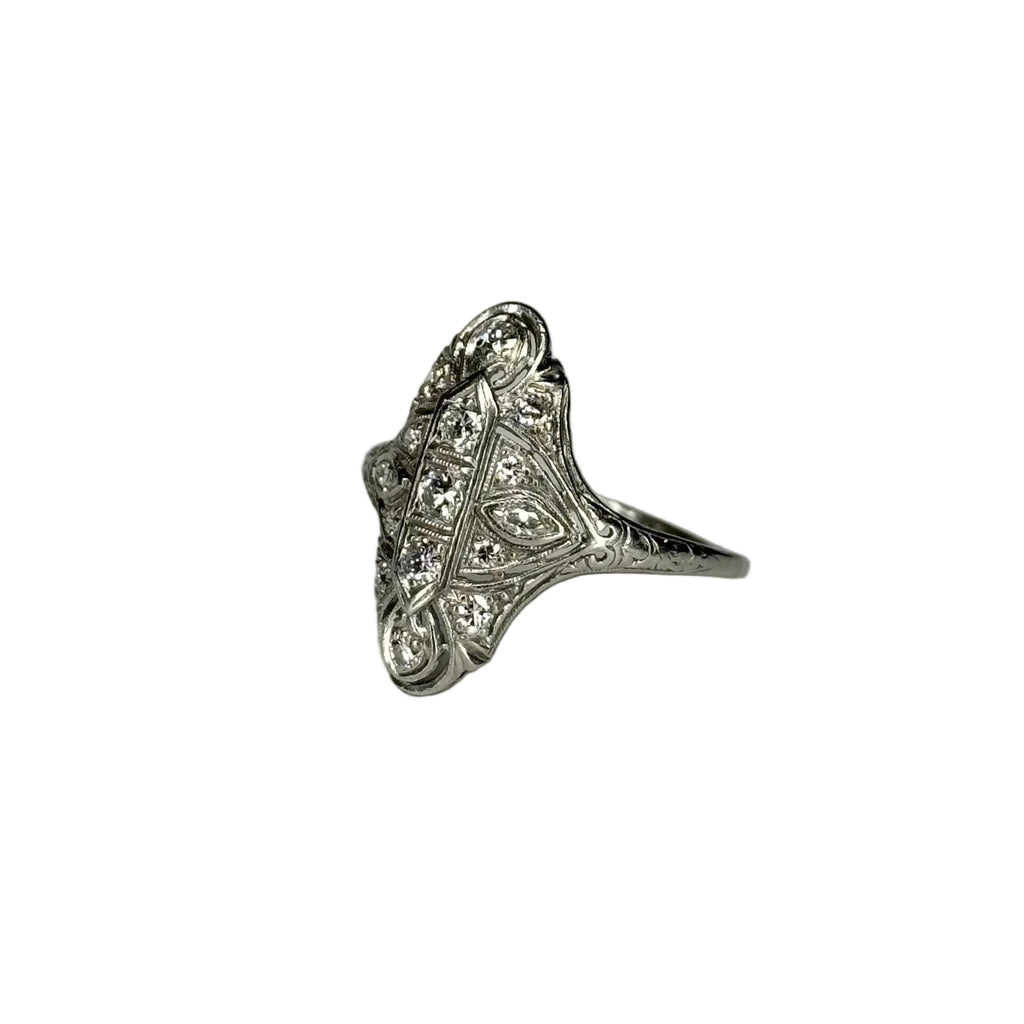 Silver ring with intricate design on a white background