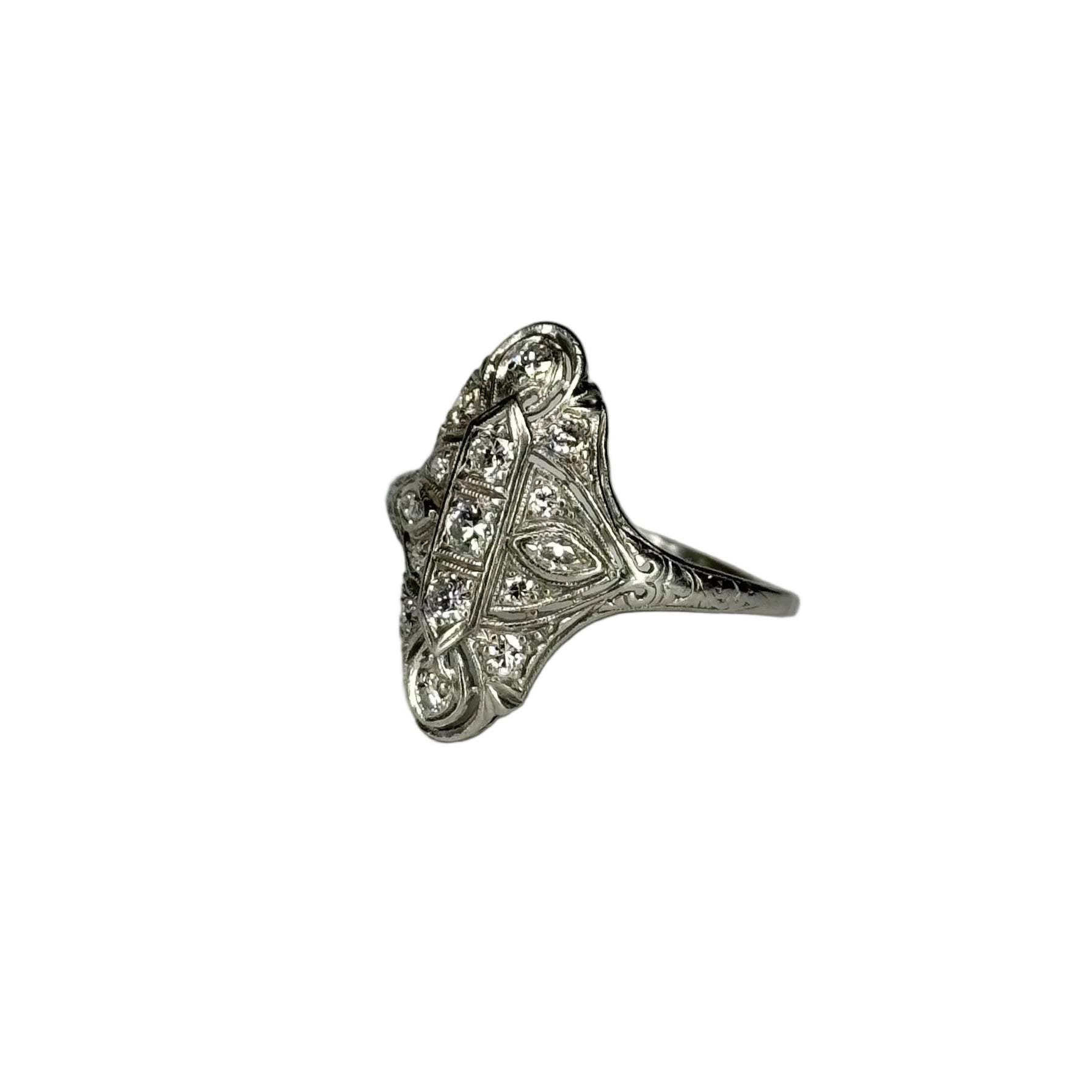 Silver ring with intricate design on a white background