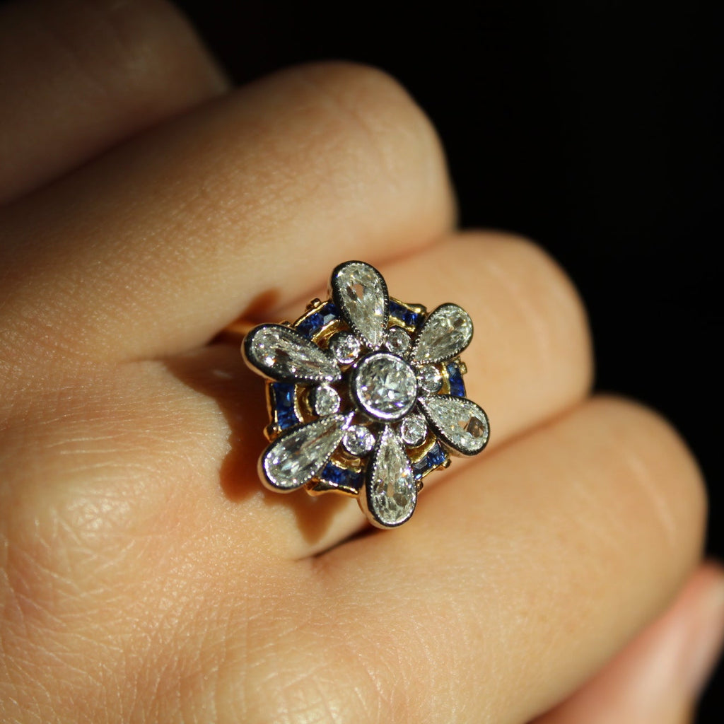 Close-up of a decorative ring on a finger with a dark background