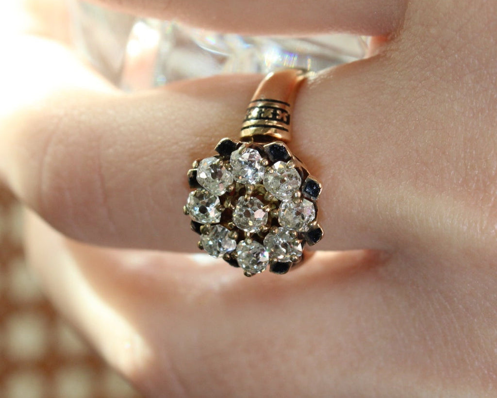 Close-up of a diamond ring on a finger with a blurred background