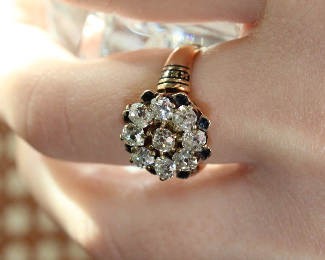 Close-up of a diamond ring on a finger with a blurred background