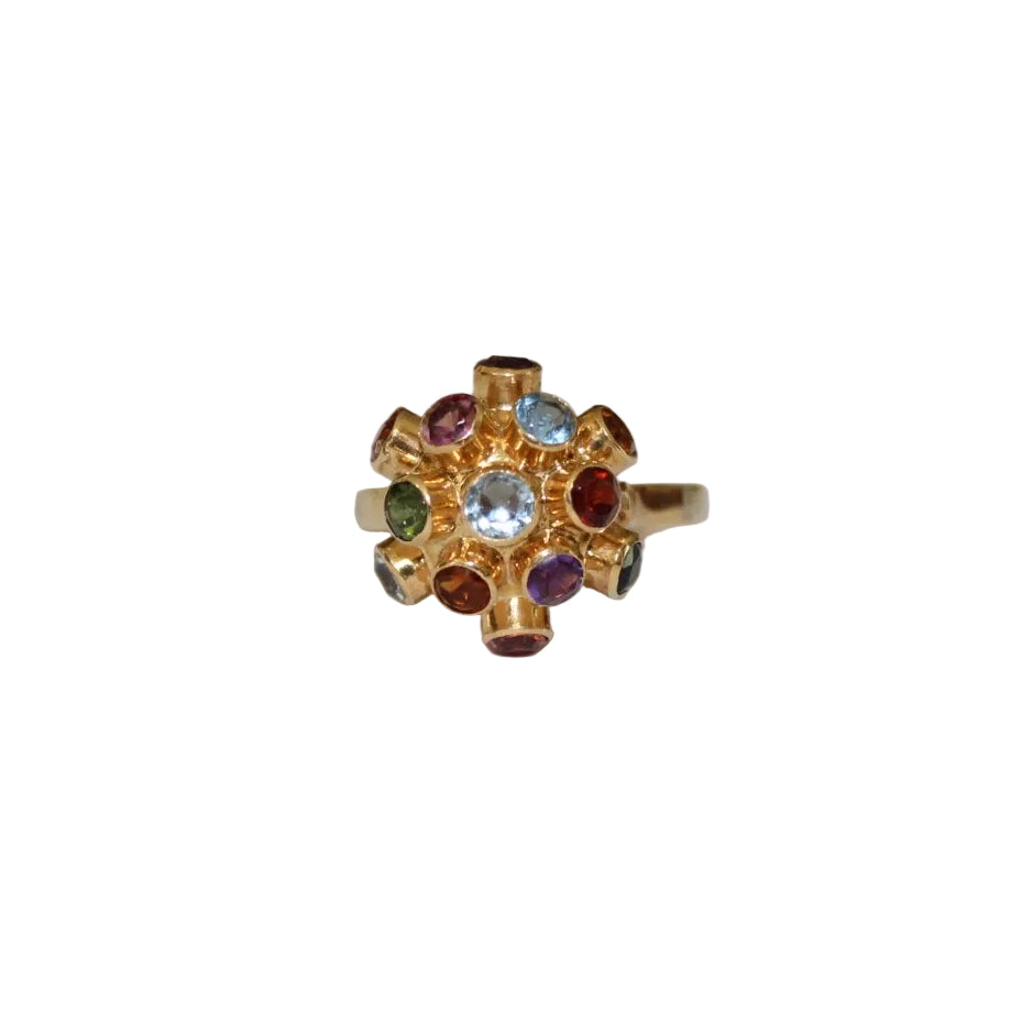 Gold ring with colorful gemstones on a white background