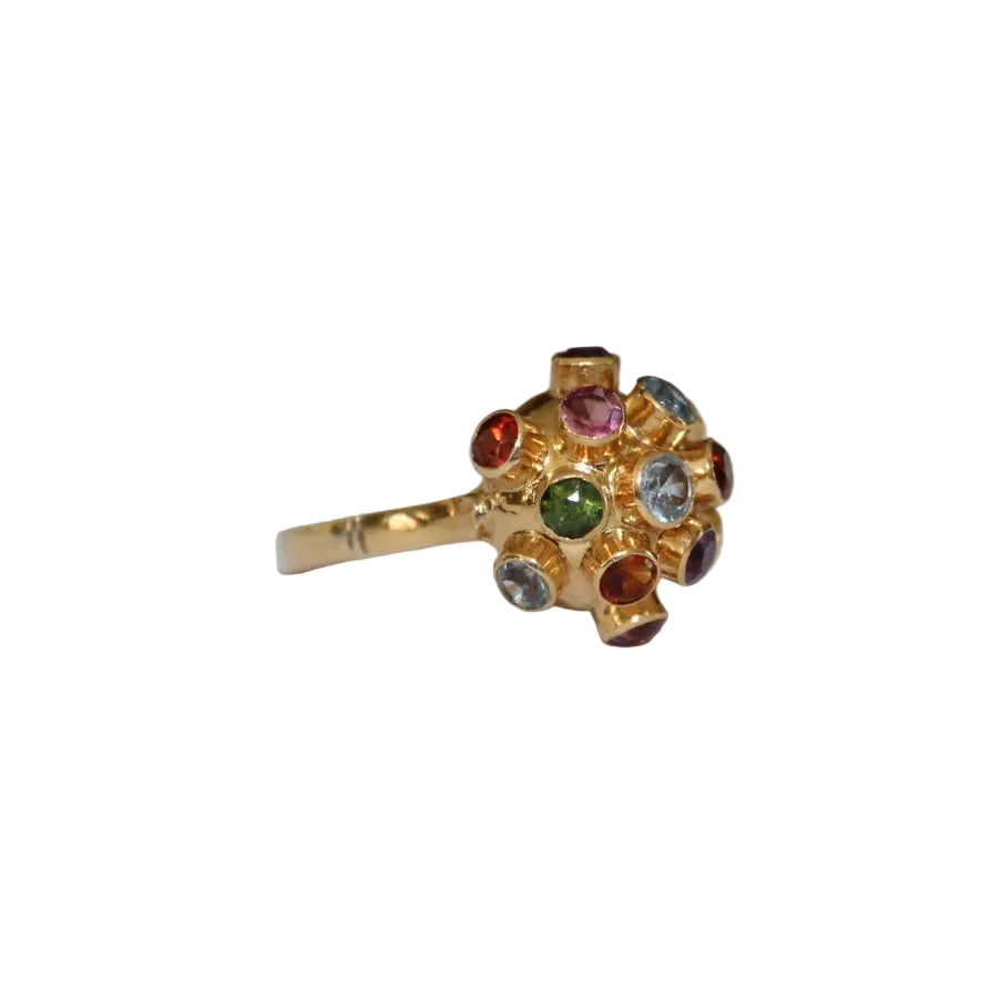 Gold ring with multicolored gemstones on a white background