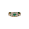 Gold ring with emerald and diamonds on a white background