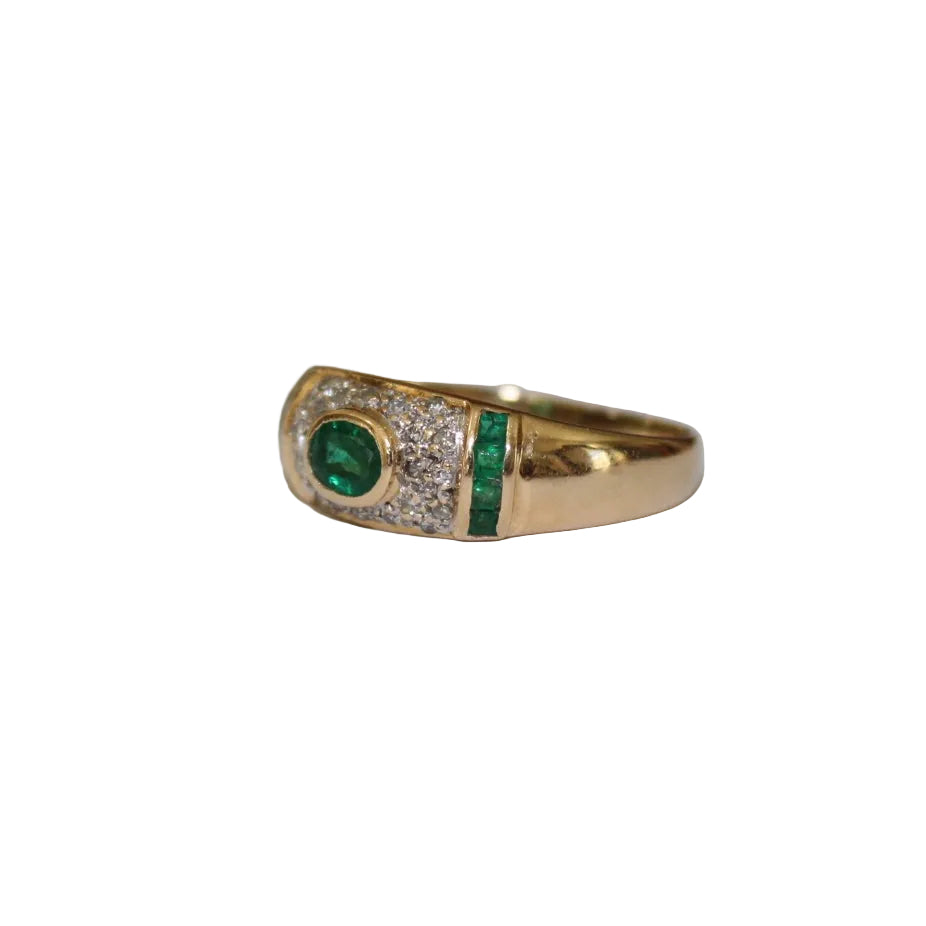 Gold ring with emerald and diamonds on a white background