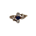 Ring with blue gemstone and diamonds on a white background