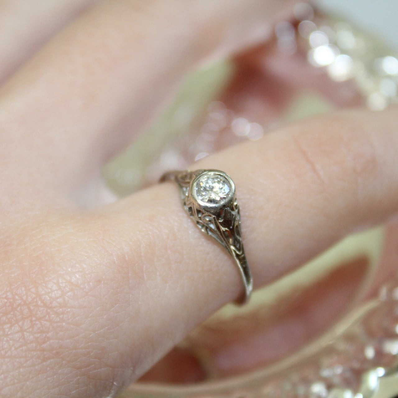 White Gold ring with a diamond on a finger