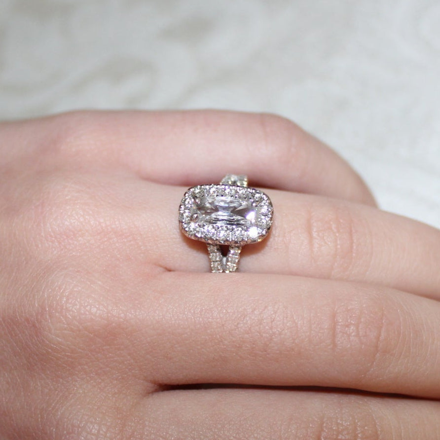 Diamond ring on a finger with a soft background