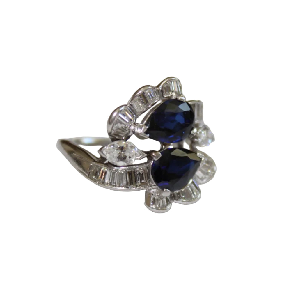 Silver ring with blue gemstones on a white background