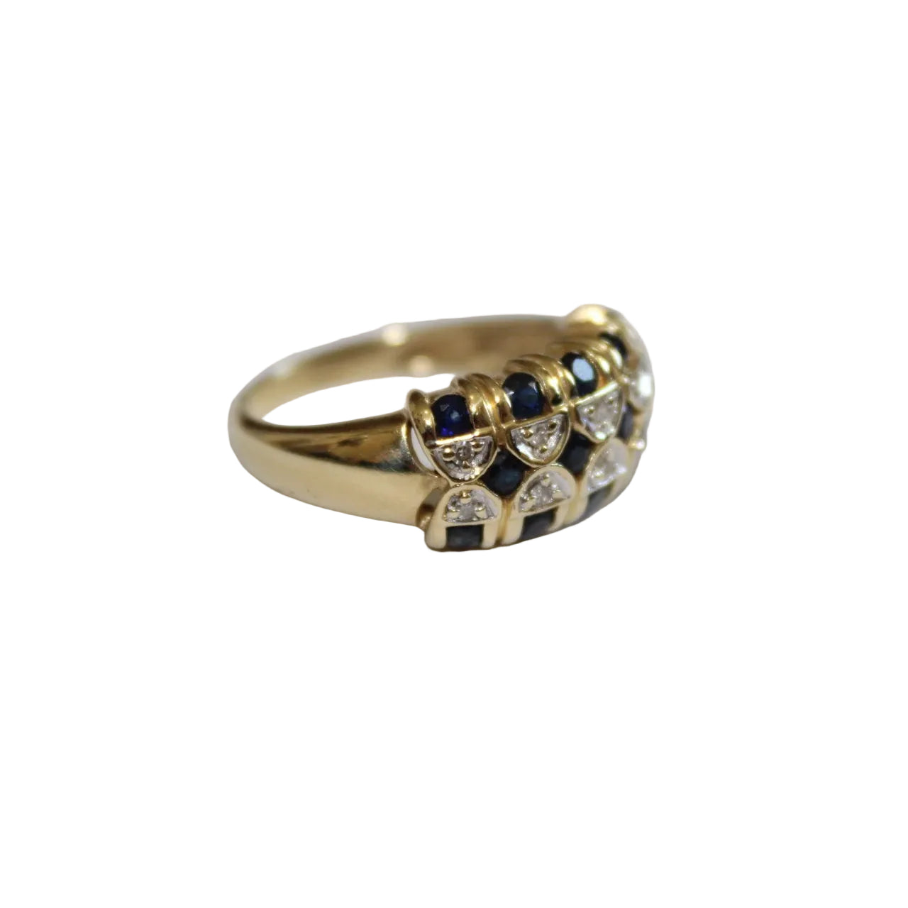 Gold ring with embedded blue and clear stones on a white background