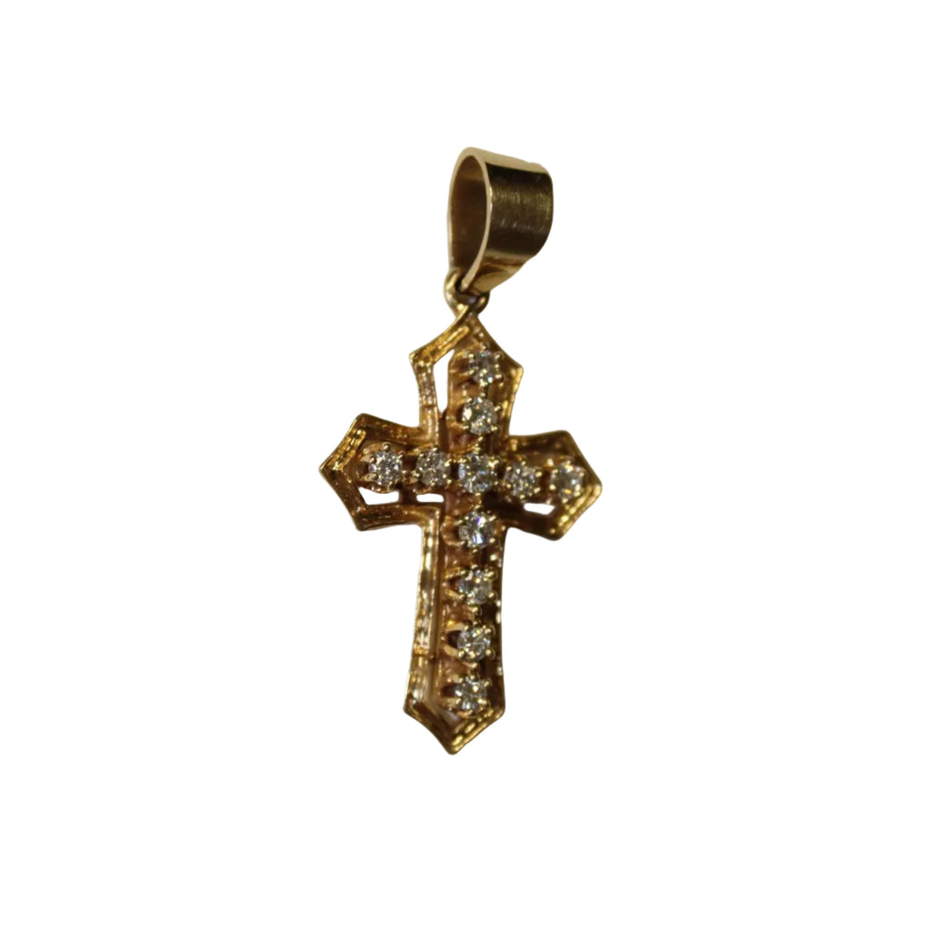 Gold cross pendant with diamonds on a light beige background