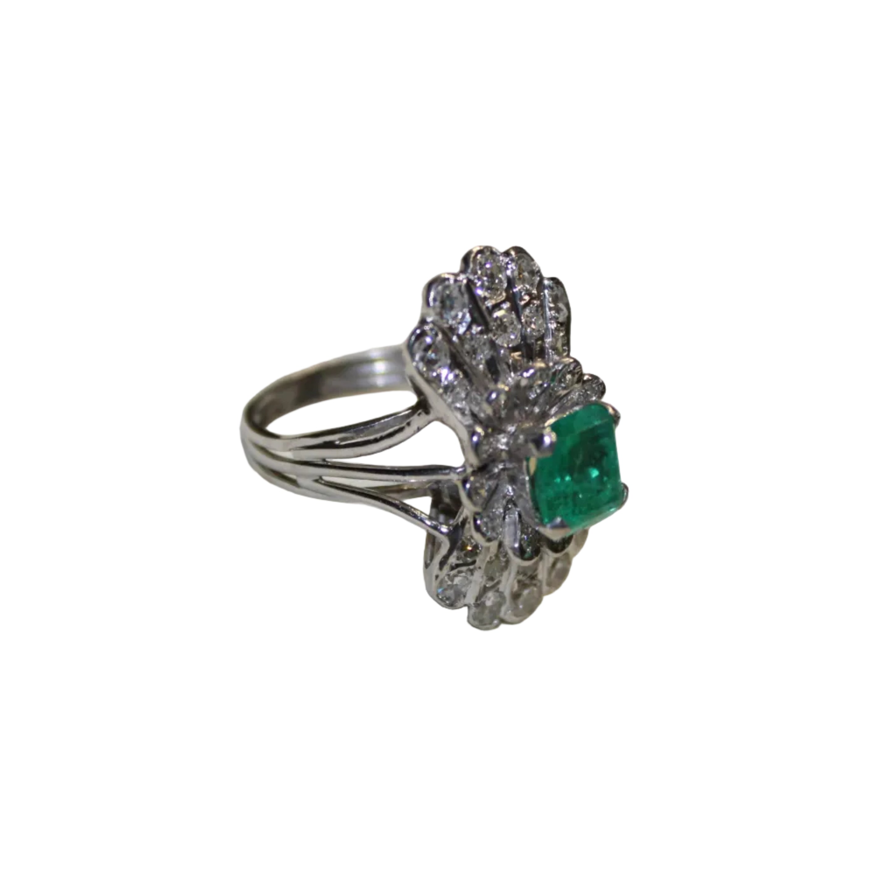 Silver ring with an emerald on a white background