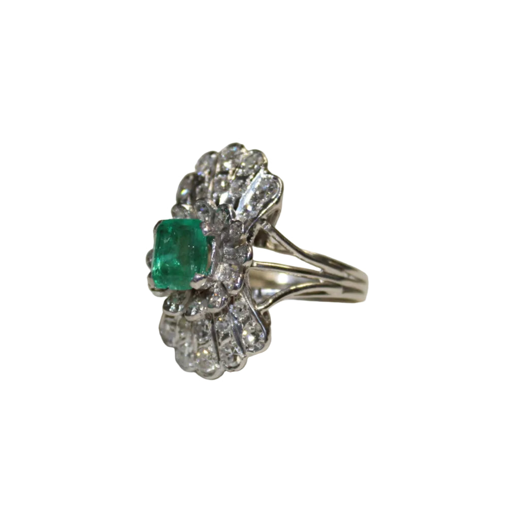 Silver ring with an emerald and diamond accents on a white background