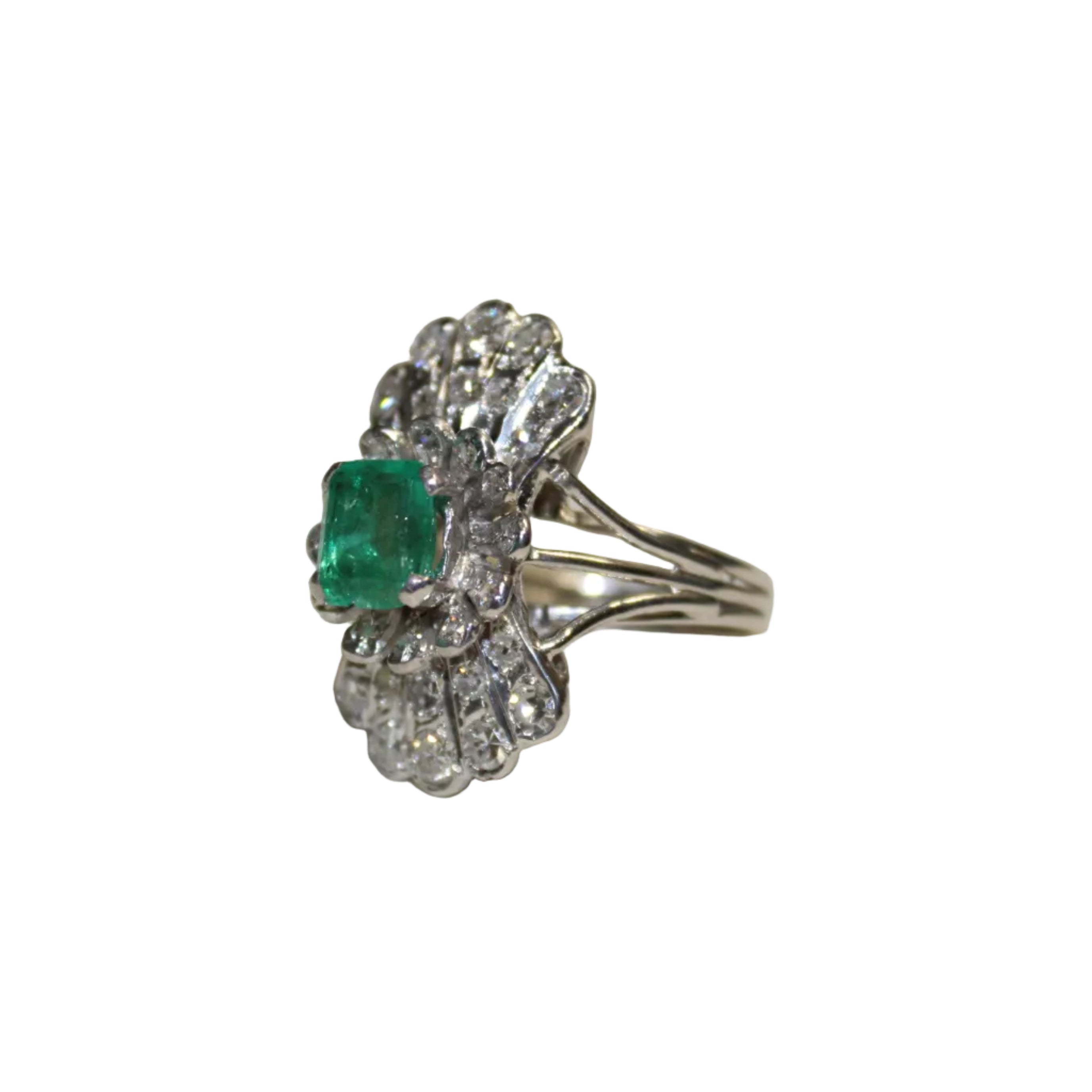 Silver ring with an emerald and diamond accents on a white background