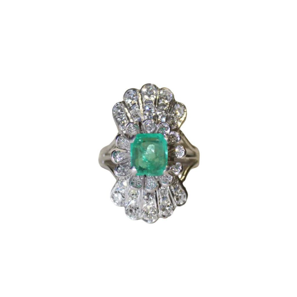 Ring with emerald and diamond accents on a white background