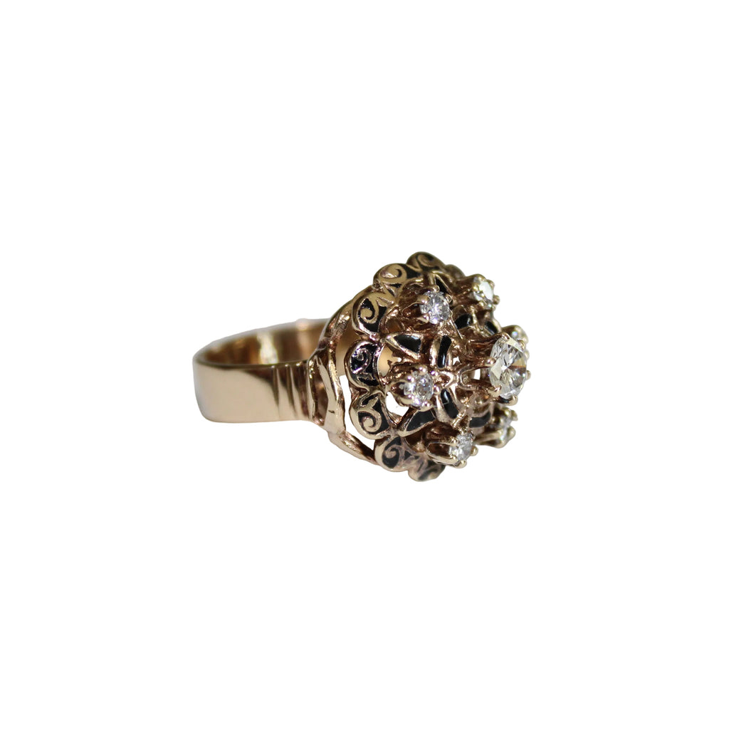 Gold ring with diamonds on a light gray background