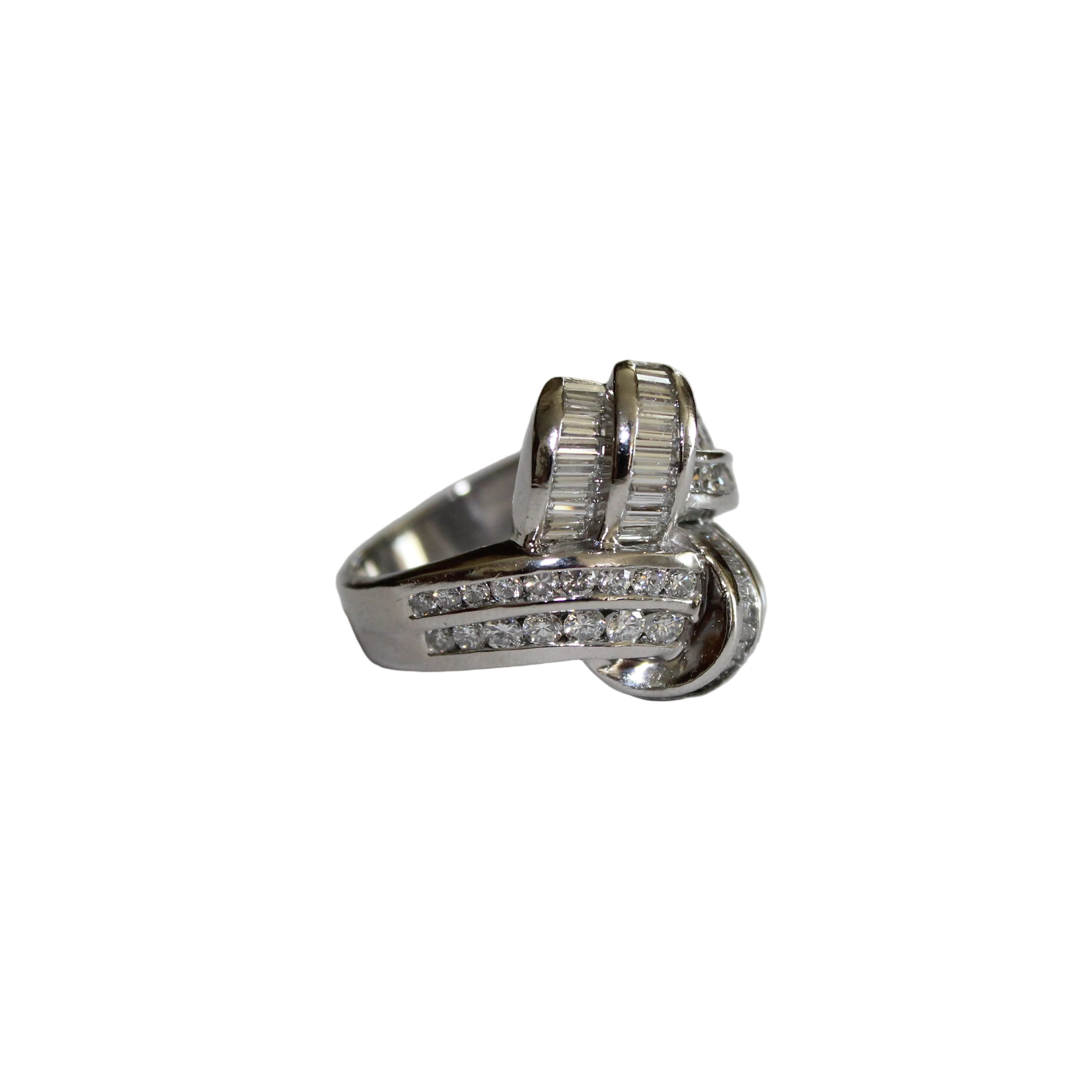 Platinum ring with diamond accents on a light gray surface