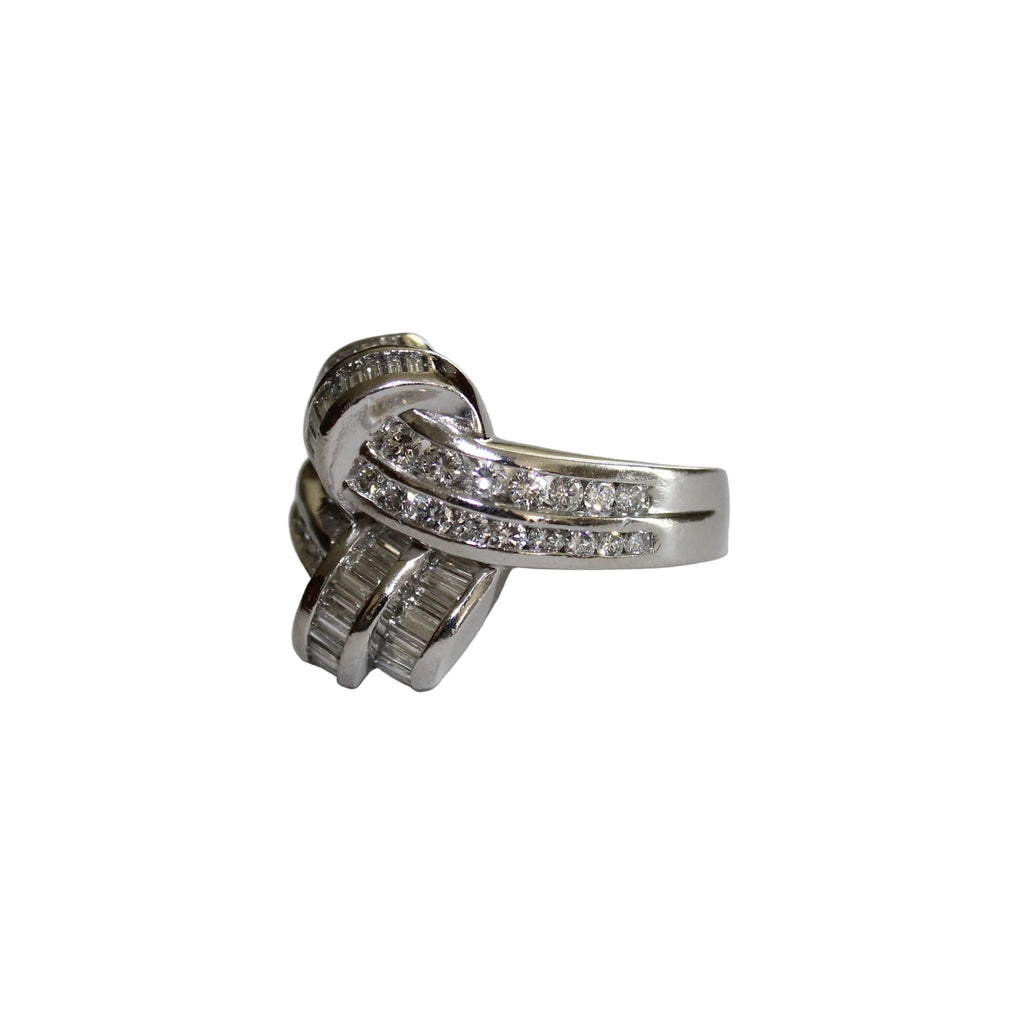 Platinum ring with diamond accents on a light gray surface