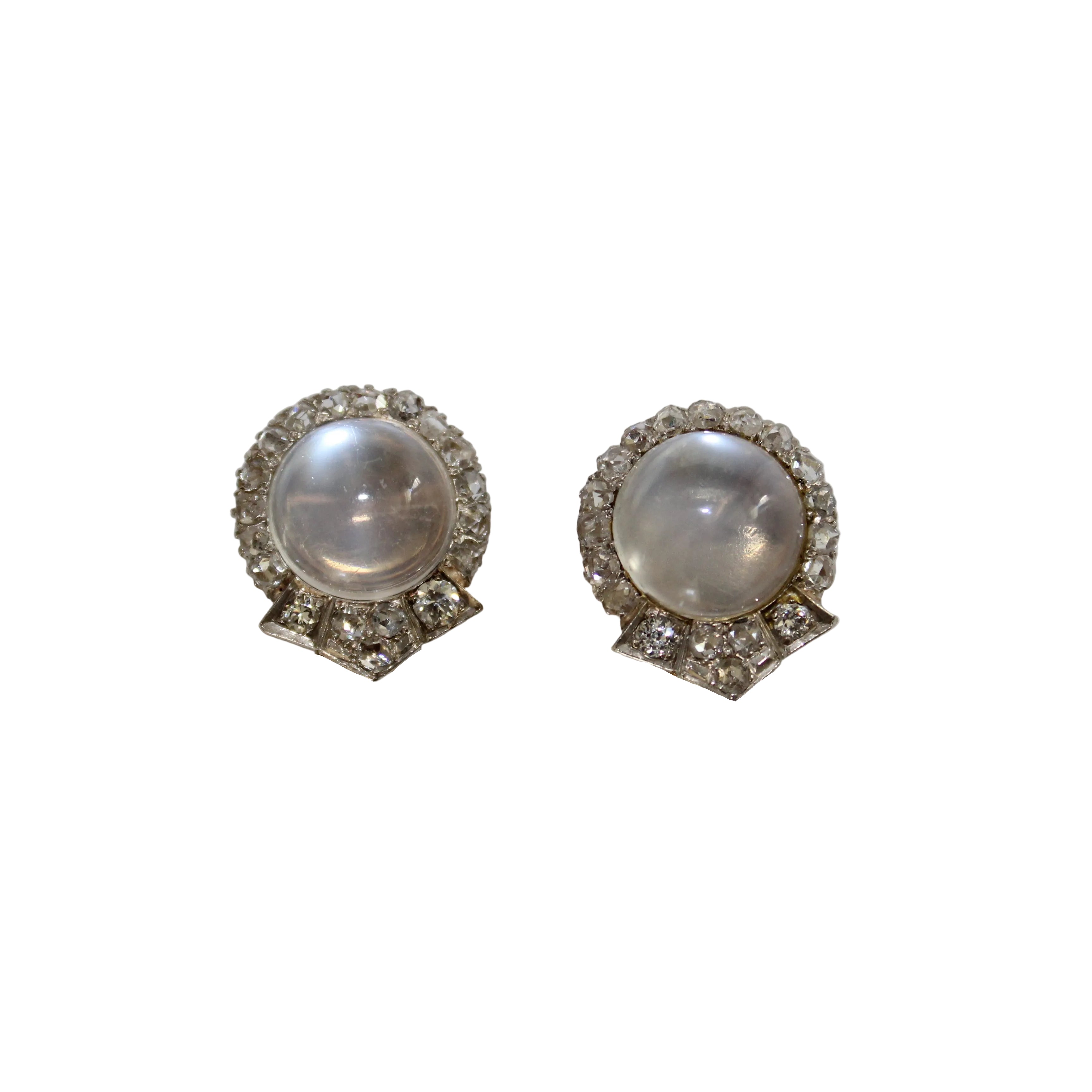 Pair of earrings with a central gemstone and diamond-like stones on a light gray background