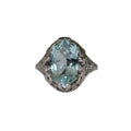 Ring with a large light blue gemstone on a white background