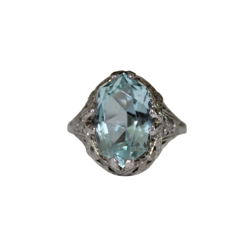 Ring with a large light blue gemstone on a white background