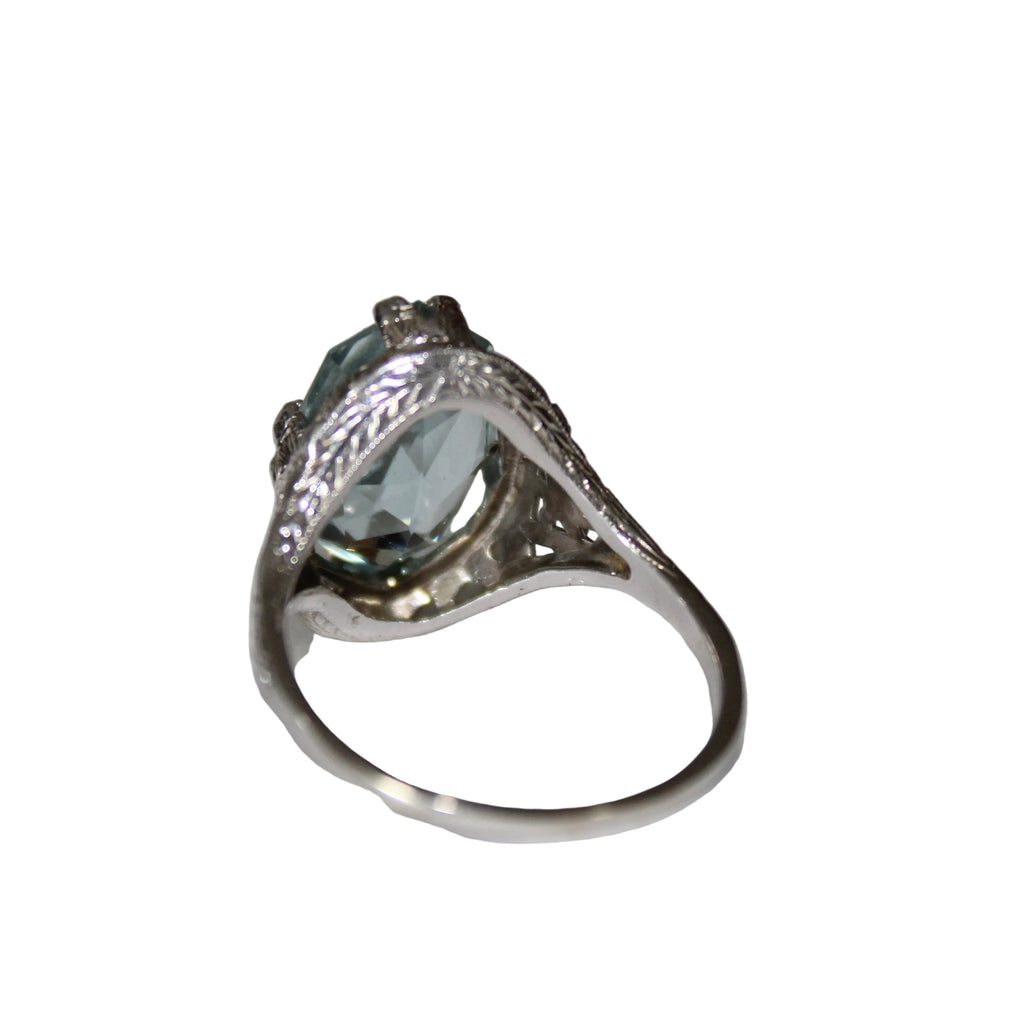 Silver ring with a blue gemstone on a light gray background
